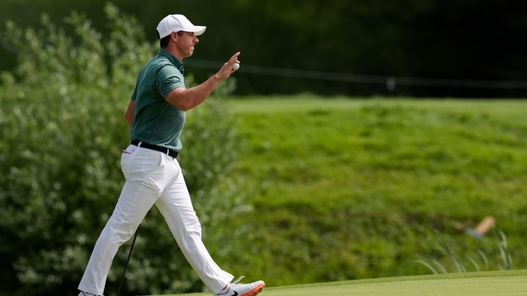 Rory McIlroy, of Ireland, acknowledges the crowd after as he...