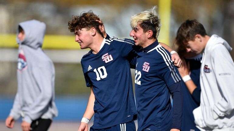 Smithtown West's Peyton McGrade, left, hugs Tom Natale after their...