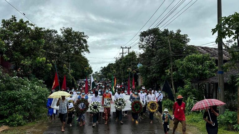 Demonstrators march during a rally to mark the 77th anniversary...