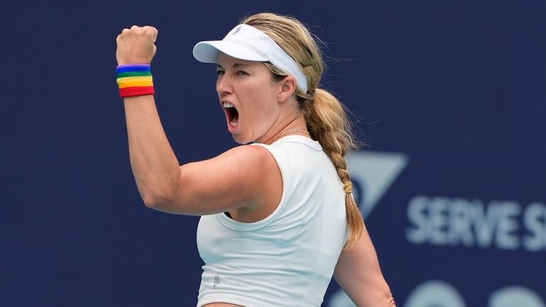 Danielle Collins reacts after winning a point against Caroline Garcia,...