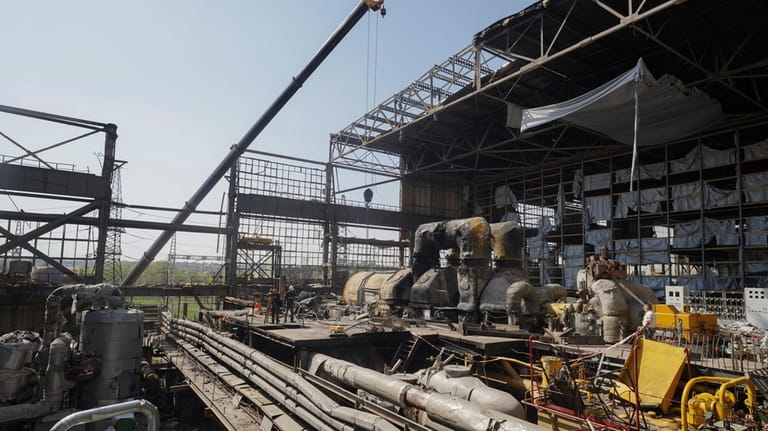 Workers repair damaged thermal power plant, one of the country's...