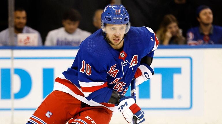 Rangers left wing Artemi Panarin (10) skates with the puck...