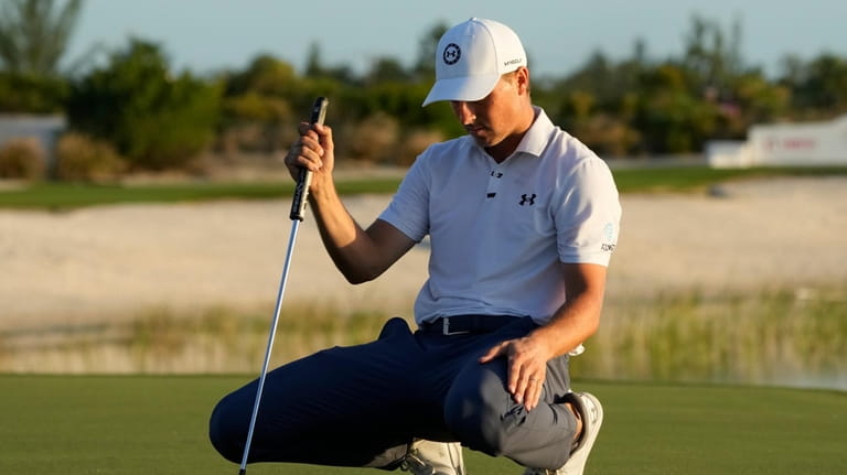 Jordan Spieth, of the United States, lines up his putt...