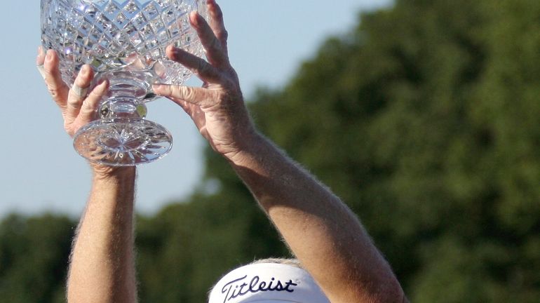 FILE -Andy Bean holds up the trophy after winning the...