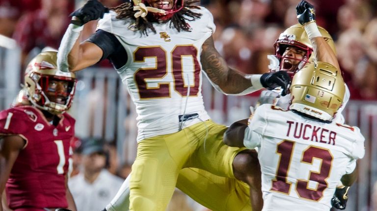 Boston College's KP Price (20), Khari Johnson (3) and Max...