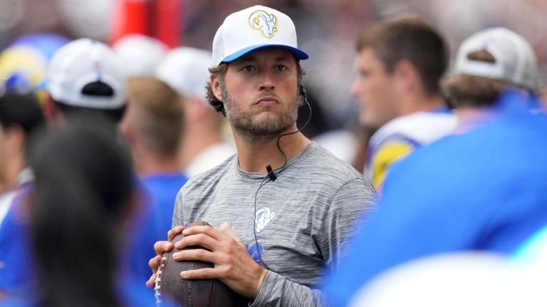 Los Angeles Rams quarterback Matthew Stafford throws on the sideline...