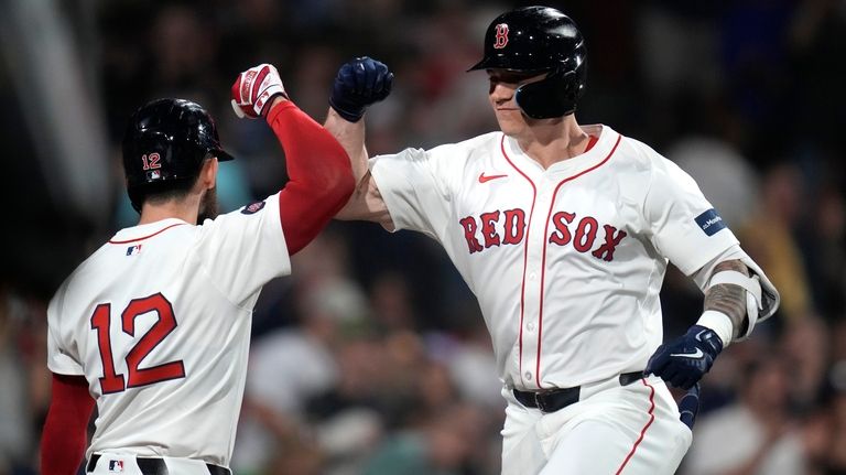 Boston Red Sox's Tyler O'Neill, right, is congratulated by Connor...