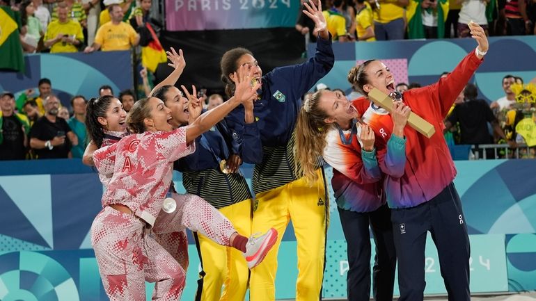 Gold medalists, Brazil's Eduarda "Duda" Santos Lisboa, center left, and...