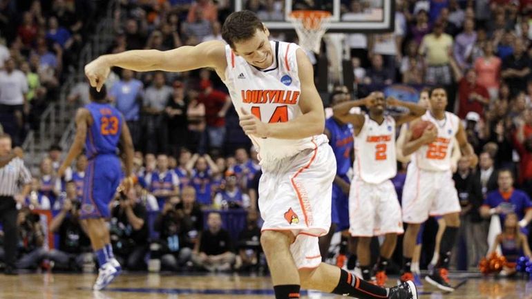 Louisville's Kyle Kuric (14) celebrates his team's 72-68 win over...