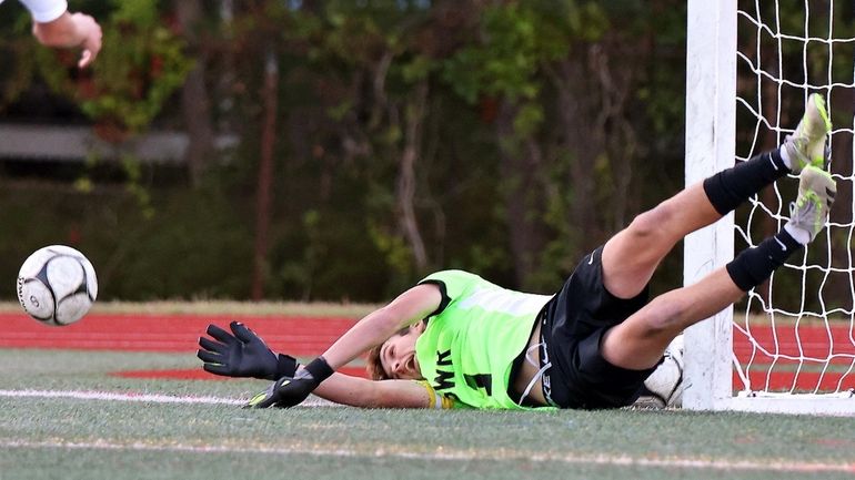 Shoreham-Wading River keeper Kyle Rose makes the diving save on...