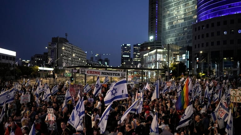 People protest against Israeli Prime Minister Benjamin Netanyahu's government and...