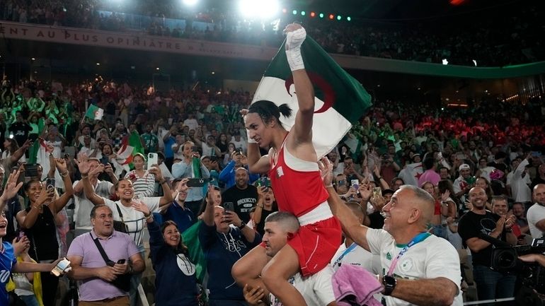 Algeria's Imane Khelif celebrates after defeating China's Yang Liu to...