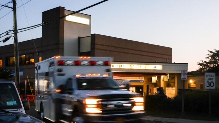 An ambulance pulls out of the ambulance bay at the emergency...