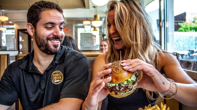 John and Alyson Kanaras enjoy a burger at their new...