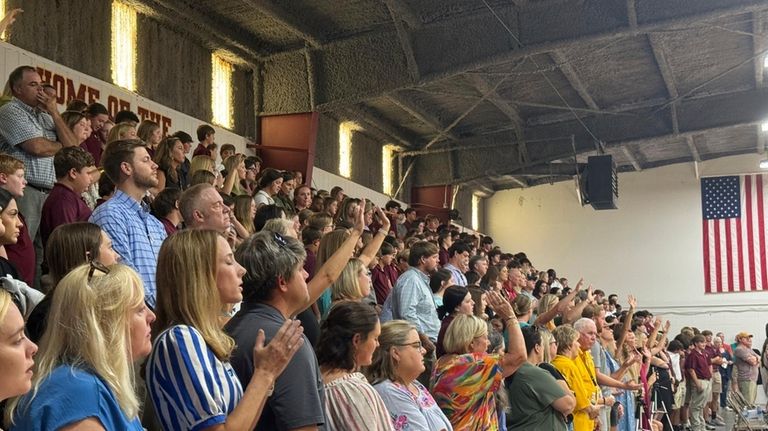 Students, teachers and community members pack the Morgan Academy gym...