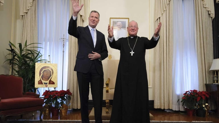 Mayor Bill de Blasio poses for photographs with Cardinal Timothy...