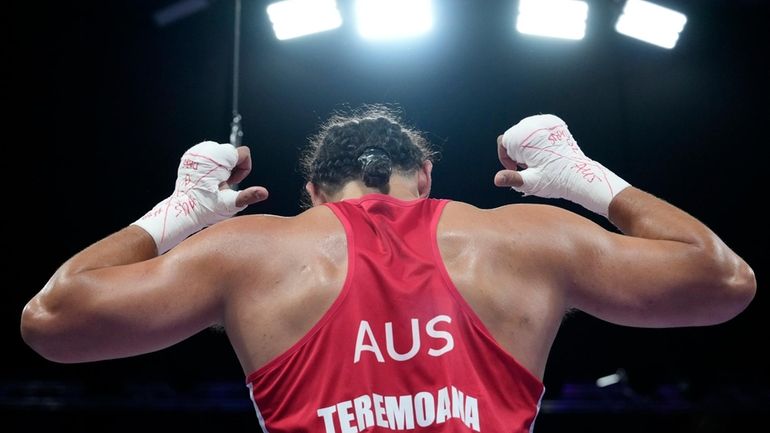 Australia's Teremoana Teremoana celebrates after defeating Ukraine's Dmytro Lovchynskyi in...