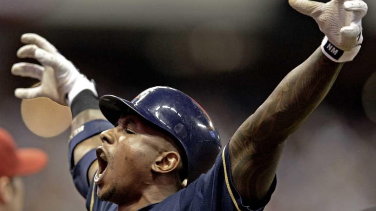Milwaukee Brewers' Nyjer Morgan reacts after hitting a two-run scoring...