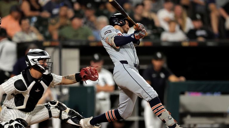 Detroit Tigers' Zach McKinstry, right, hits an RBI single during...