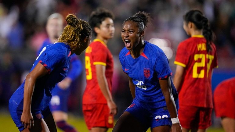 United States' Jaedyn Shaw, center right, reacts with Midge Purce...