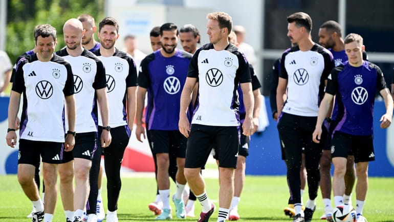 Germany's head coach Julian Nagelsmann, front center, players and staff...