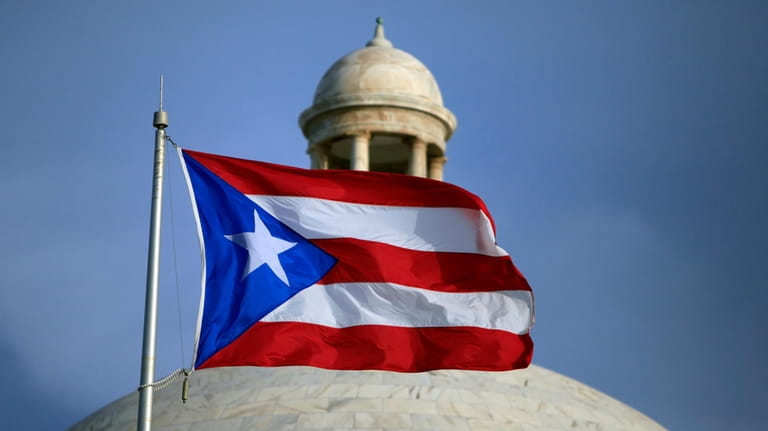A Puerto Rican national flag flies in front of the...
