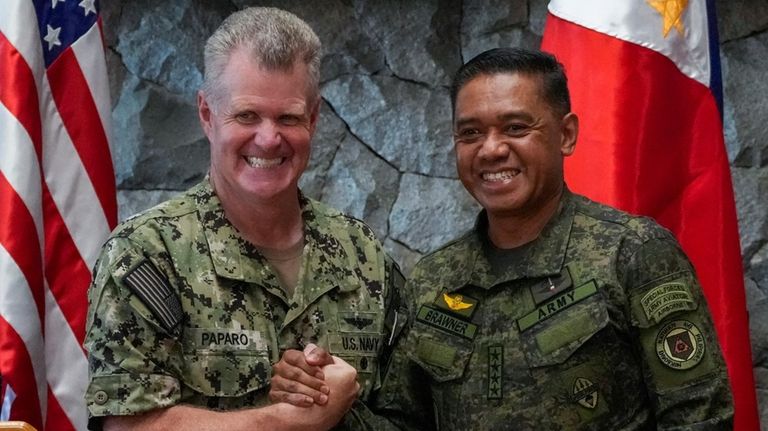 U.S. Indo-Pacific Command Commander Admiral Samuel Paparo, left, and Philippines...