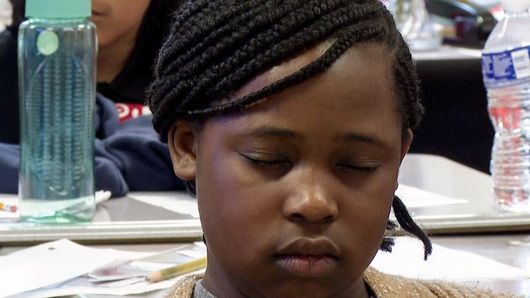 Aniyah Woods meditates during a mindfulness session in her classroom...