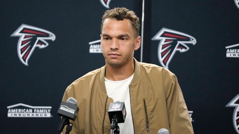 Atlanta Falcons quarterback Desmond Ridder talks after an NFL football...