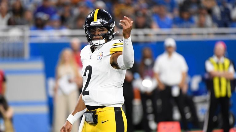 Pittsburgh Steelers quarterback Justin Fields signals during the first half...