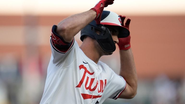 Minnesota Twins' Matt Wallner celebrates while running the bases after...