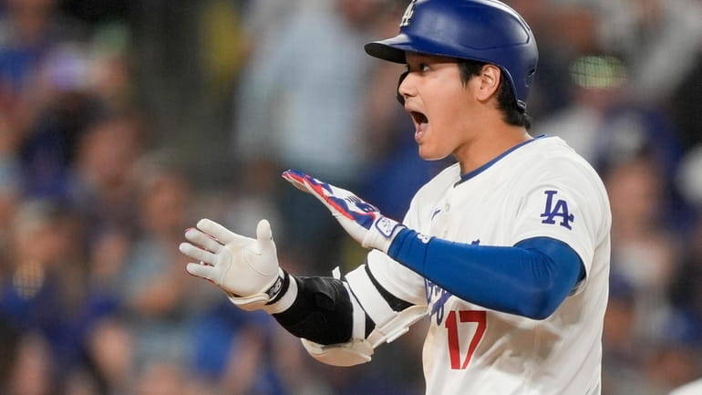 Los Angeles Dodgers designated hitter Shohei Ohtani celebrates his go-ahead...