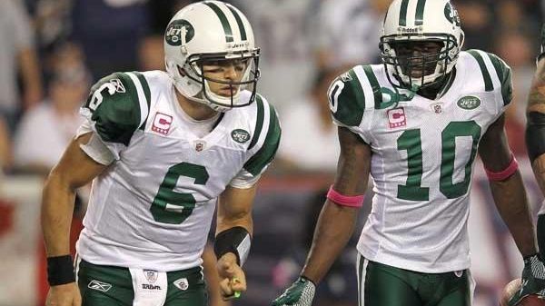 Mark Sanchez #6, left, and Santonio Holmes #10 of the...