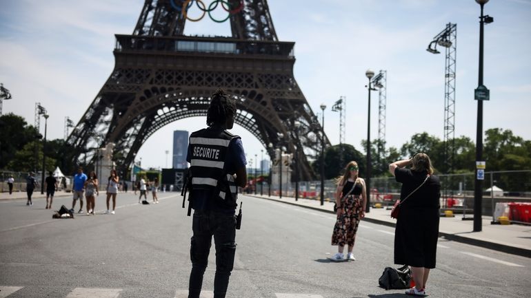 A security officer watches people taken photographs in front of...