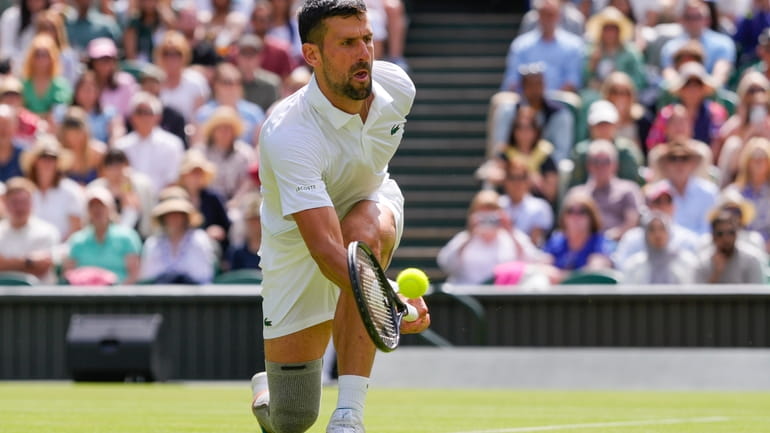 Serbia's Novak Djokovic plays a forehand return to Britain's Jacob...