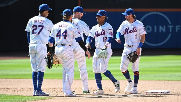 Mets players celebrate their 7-0 win against the Nationals in...