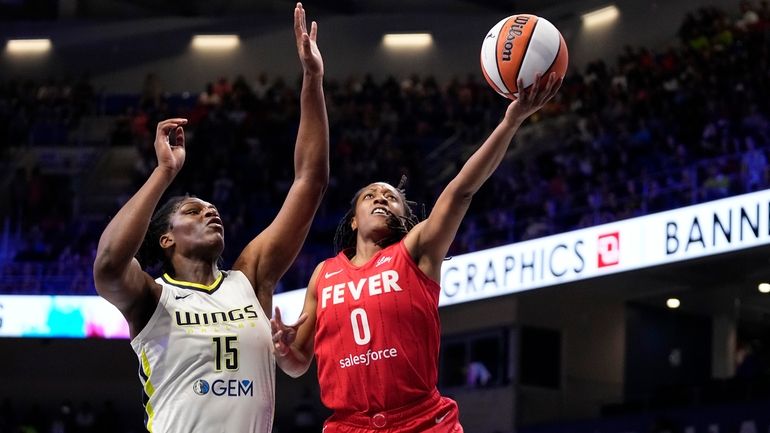 Indiana Fever's Kelsey Mitchell (0) leaps to the basket to...