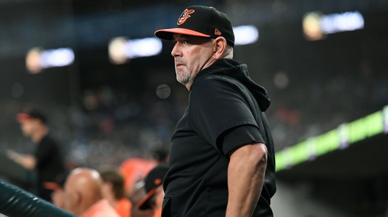 Baltimore Orioles manager Brandon Hyde watches from the dugout in...