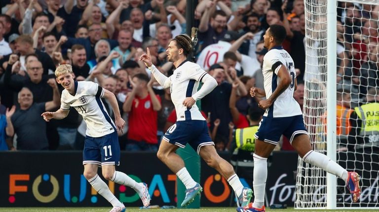 England's Jack Grealish, centre, celebrates after scoring his side second...