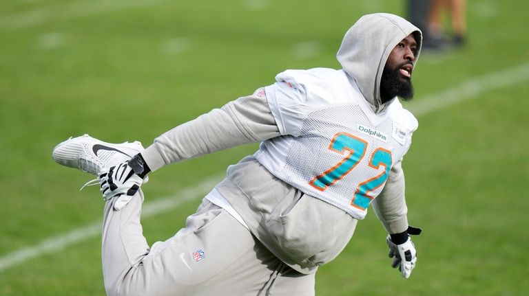 Miami Dolphins offensive tackle Terron Armstead (72) stretches during a...