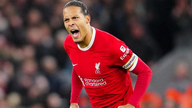 Liverpool's Virgil van Dijk celebrates after scoring his side's first...