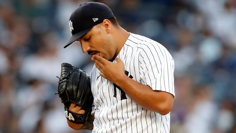 Nestor Cortes of the Yankees stands on the mound after surrendering...