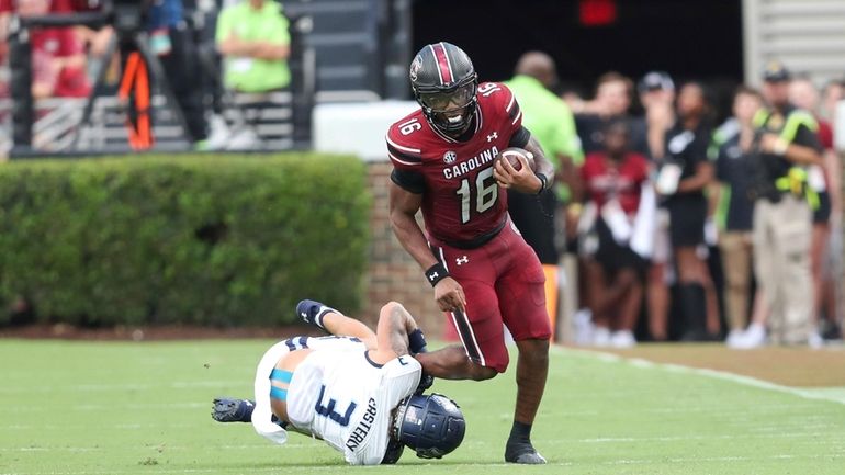 Old Dominion safety Mario Easterly (3) tackles South Carolina quarterback...