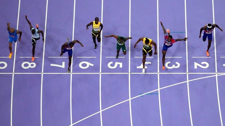 Noah Lyles, of the United States, in lane seven, wins...