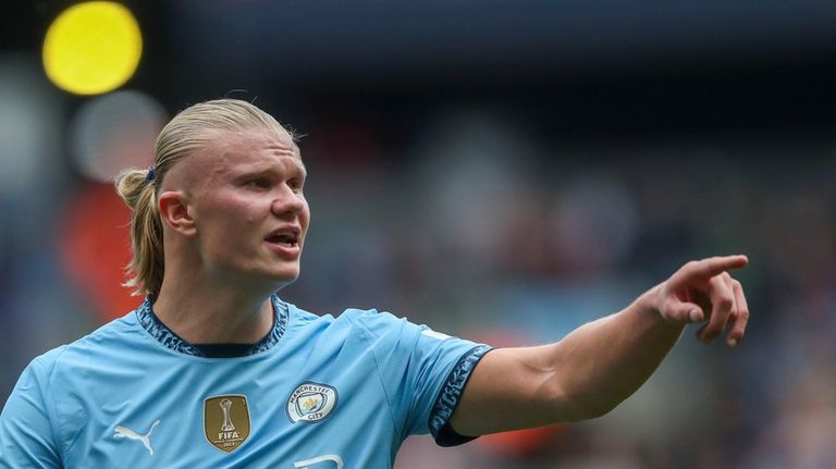 Manchester City's Erling Haaland gives instructions to his players during...