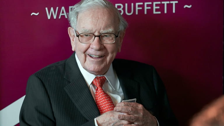 Warren Buffett, chairman and CEO of Berkshire Hathaway, smiles as...