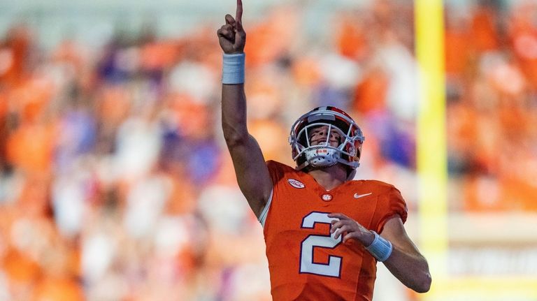 Clemson quarterback Cade Klubnik reacts after throwing a touchdown pass...