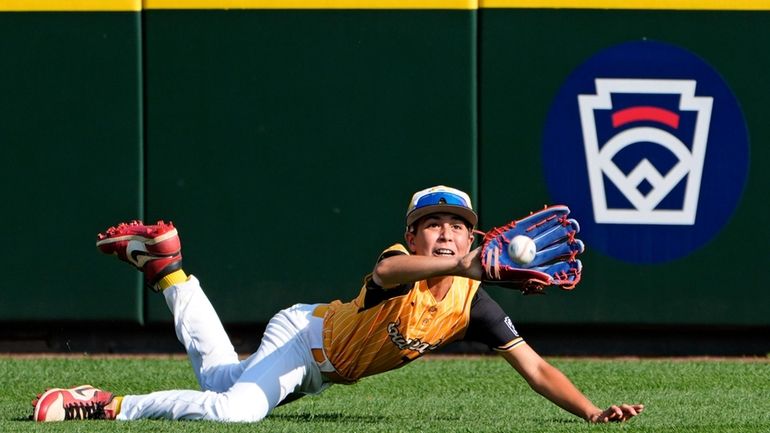 Lake Mary, Fla.'s Jacob Bibaud dives but cannot catch a...