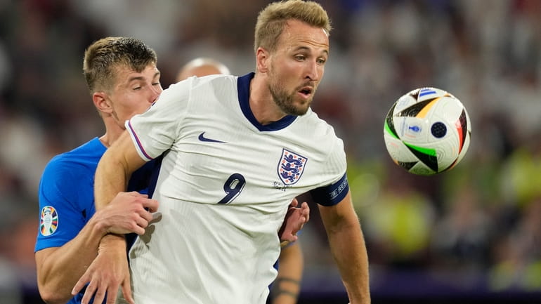England's Harry Kane challenges for the ball with Slovenia's Jaka...
