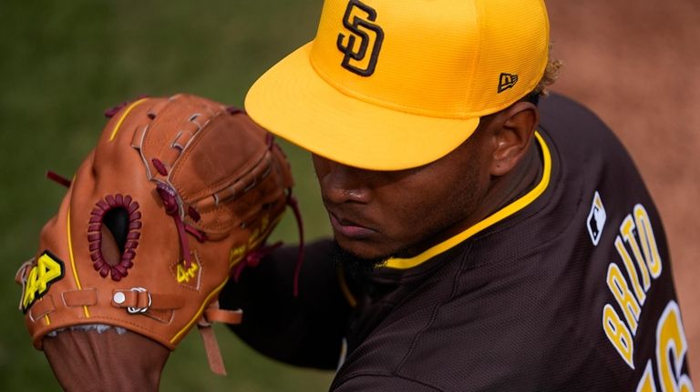 San Diego Padres starting pitcher Jhony Brito warms up in...